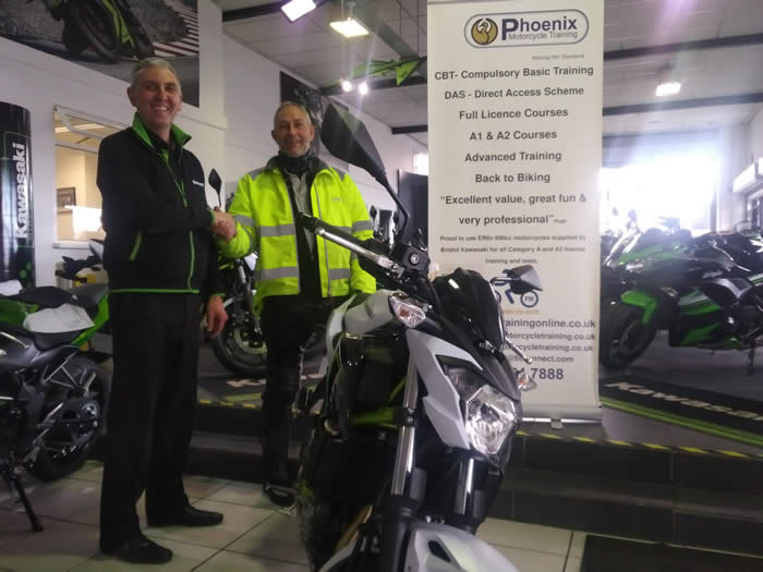 Mike receiving one of the Z650 KRTS bikes from Steve at Kawasaki